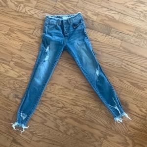 Trendy distressed black label jeans. Cute fray on waist and ankle.